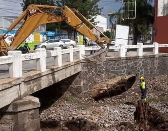 Retiran troncos arrastrados por la corriente en el cause del Río Palo Grande